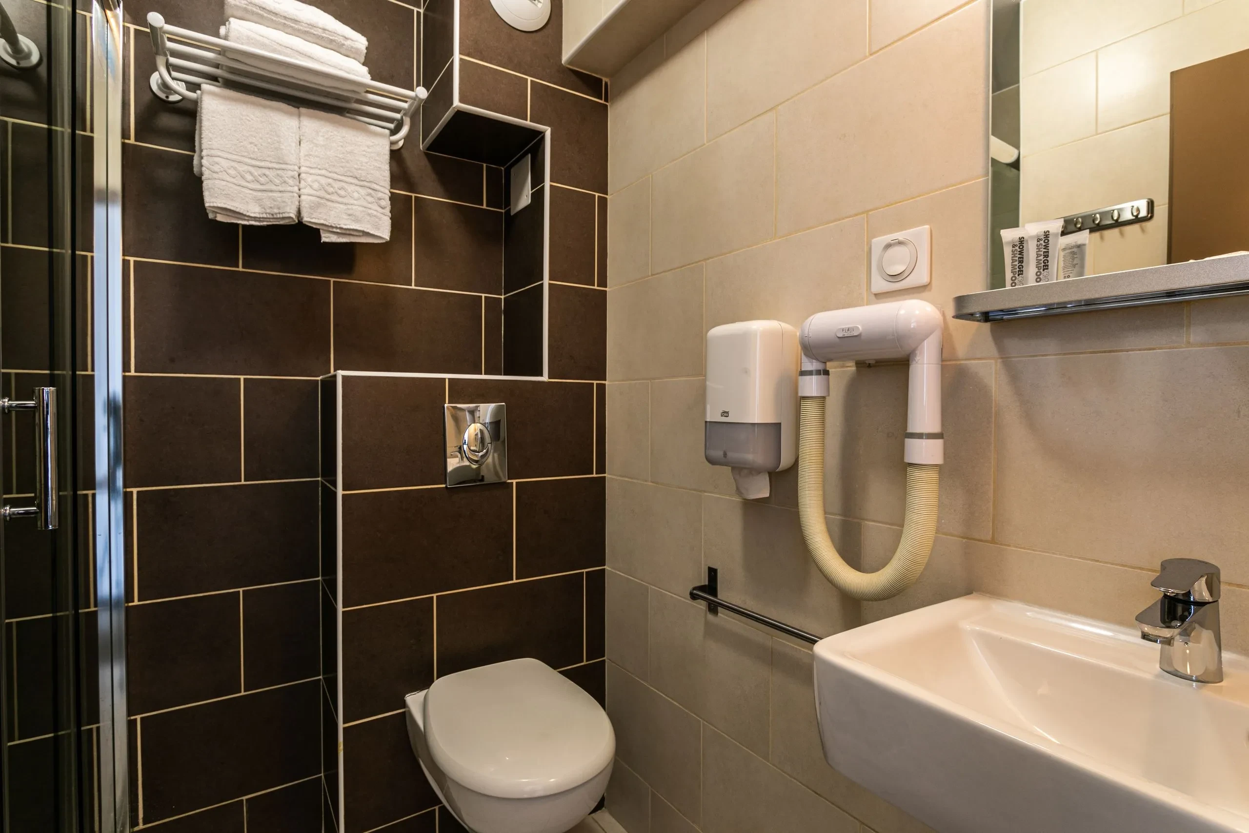 Salle de bains moderne avec toilettes et lavabo.