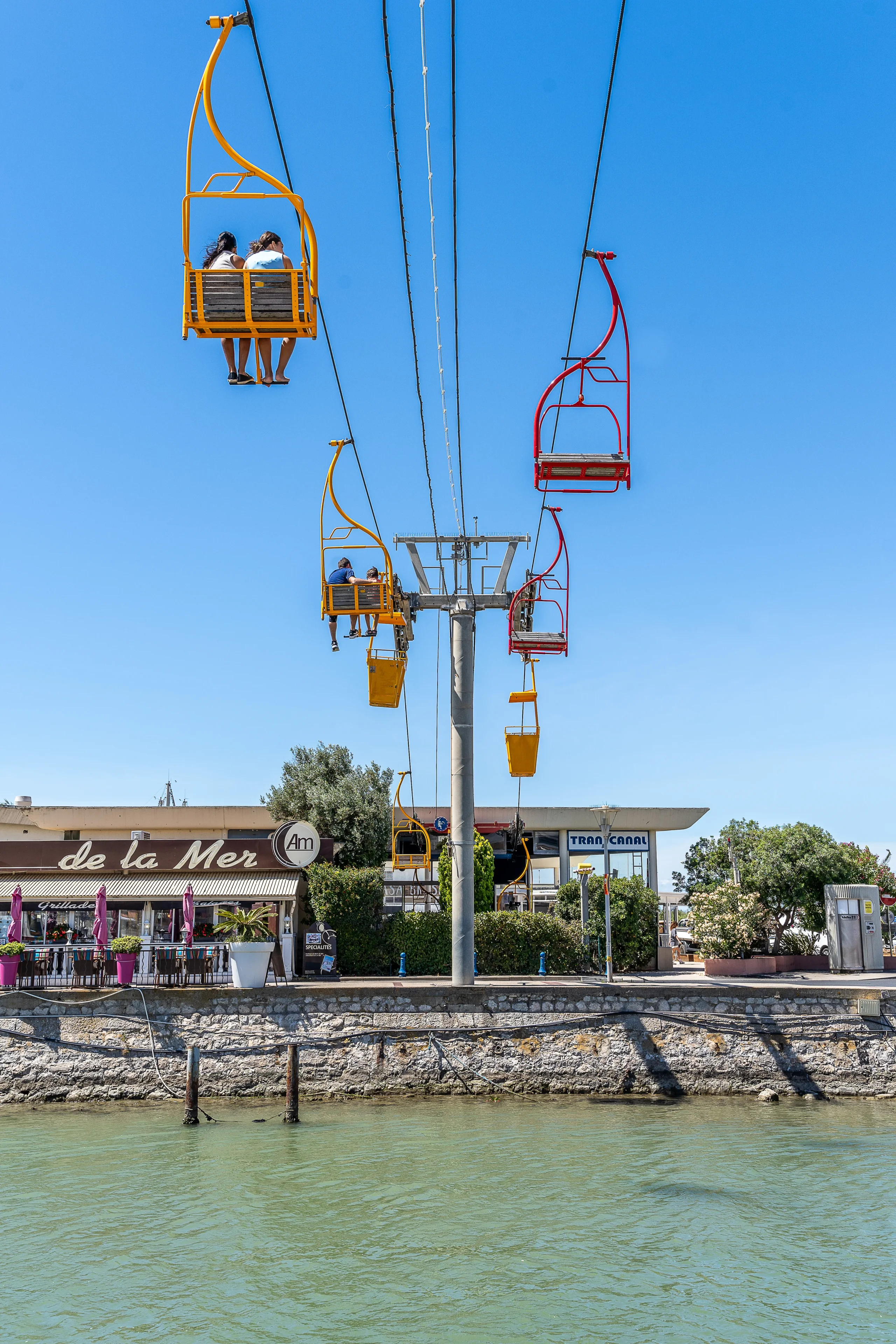 Télésiège coloré au-dessus d'un canal - Vacances Palavas-les-Flots - Hôtel du Midi Palavas